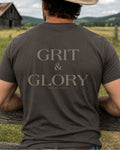 Cowboy wearing Grit and Glory western graphic tee on horseback at sunset