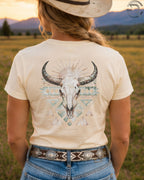 Cowgirl wearing boho bull skull western graphic tee in sunset country field
